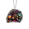 Close-up of Oscar Piastri helmet acrylic ornament showing neon Miami skyline, Monster Energy logo, 81 visor and ball chain